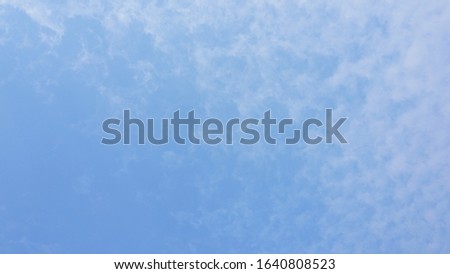 The background of the blue sky is drained by thin white clouds.