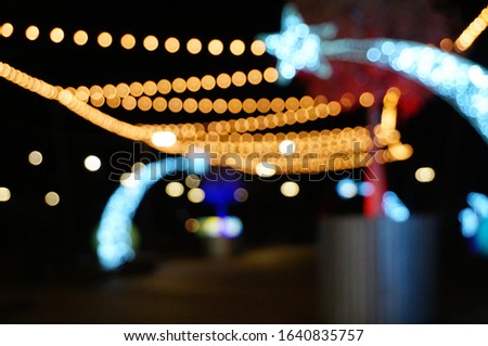 Blurred background. Christmas decorations in the city. Festive illumination at night.