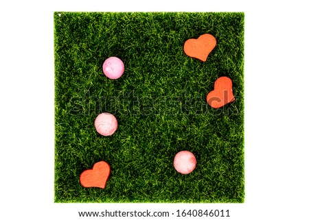 Hearts on the green grass. On white background.