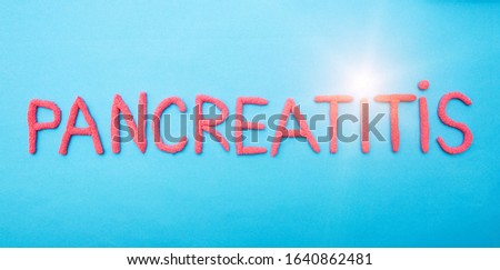 The word pancreatitis in red letters on a blue background. Pancreatic disease concept, epigastric pain and inflammation, medical Royalty-Free Stock Photo #1640862481