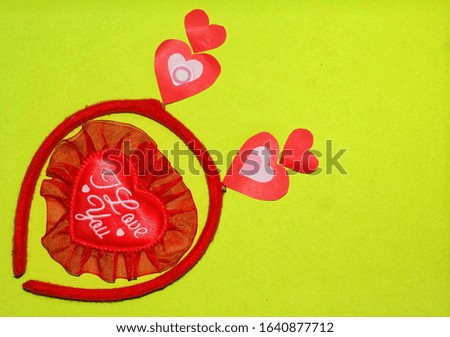 Red hair band and heart shape on the bright green paper for background image