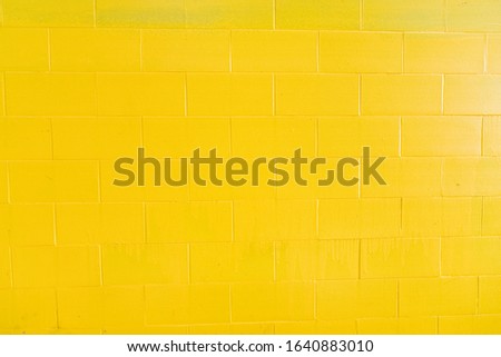 Background of yellow painted bricks wall, Tuscany in Italy
