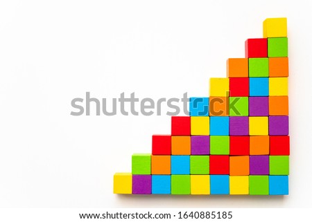 Toy wooden blocks as increasing graph bar on white background.