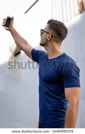 Young Hispanic Man In Casual T shirt Having Shooting Mobile Phone Selfie