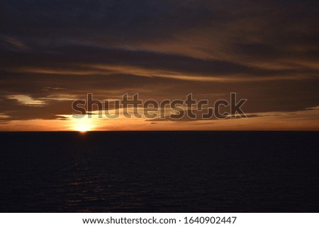 Beautiful cloudy sunset in the sea