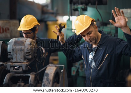 Shot of two industrial workers feeling bad with old system in the factory, the worker feels upset and show give up, Concept industrial workers with bad emotion when working time, working confliction. Royalty-Free Stock Photo #1640903278