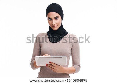 Muslim woman using tablet over white background