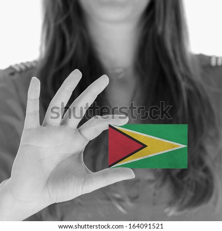 Woman showing a business card, flag of