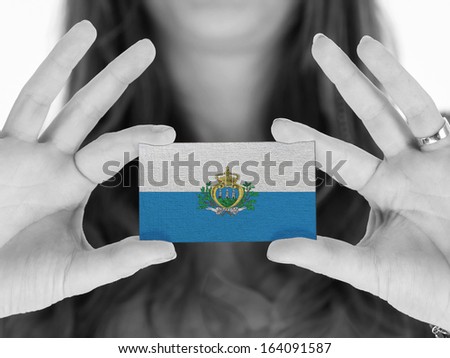 Woman showing a business card, flag of San Marino
