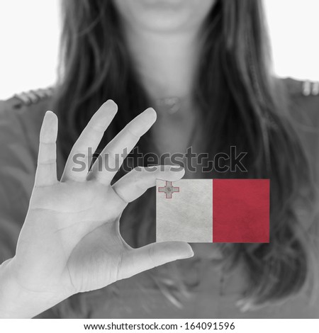 Woman showing a business card, flag of Malta