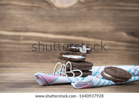 chocolate chip cookie sandwich on a colored napkin on a wooden background. wooden and red hearts. Happy Valentine's day. beautiful picture with biscuits. texture.