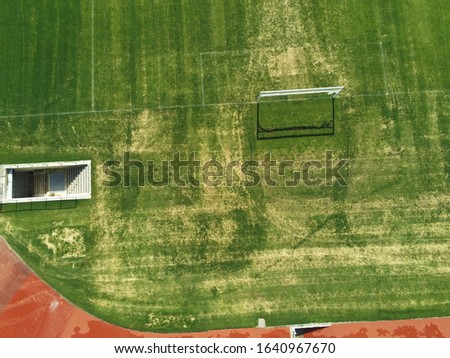 Aerial view of soccer field with the camera pointing down where we can see the entrance to the field