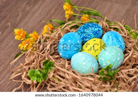 Spring Easter colorful painted eggs on the wooden background flat lay closeup top view beautiful picture. Congratulations card happy holiday