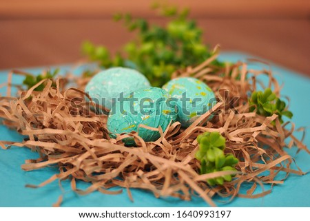 Spring Easter colorful painted eggs on the blue background flat lay closeup top view beautiful picture. Congratulations card happy holiday