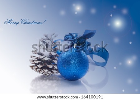 Christmas card with blue ball and fir cones