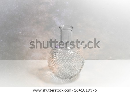 Still life photo image with a transparent glass vase with abstract background
