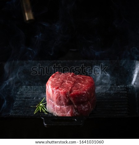 Filet Mignon steak in a pan, the process of cooking on the grill