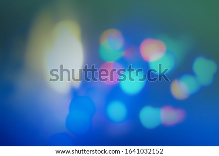 Multicolor bokeh with blue gradient background