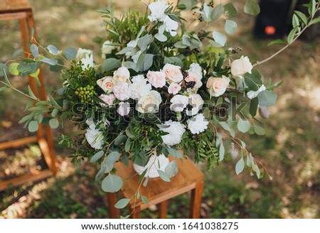 A large wedding bouquet of flowers: roses, chrysanthemums, elderberries, wildflowers. Scenery, floristry at the wedding. Photography, concept.