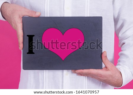 man holding sign with heart, happy valentines day concept
