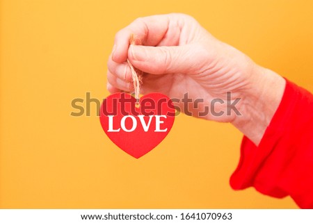 hand holding heart tags with text, valentines day