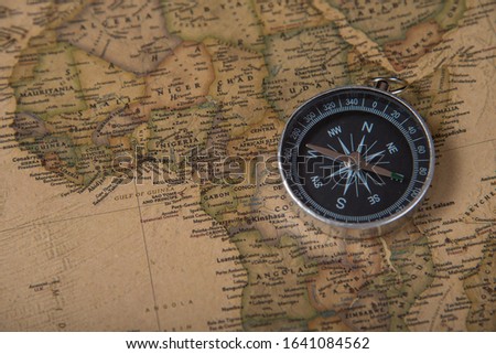 The concept of travel and adventure. Compass on detailed map.