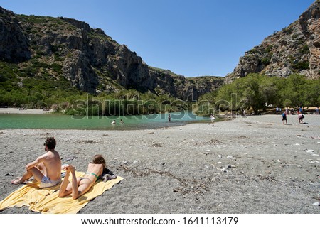 Crete, Greece, Preveli Beach, May 24, 2019: tourists enjoy Preveli beach at Libyan sea, river and palm forest, southern Crete , Greece in summer