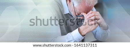 Tired senior businessman with hands on forehead; panoramic banner