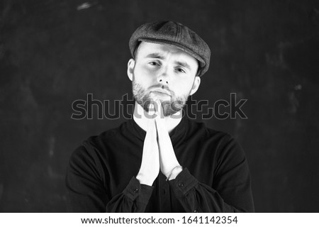 Picture of a young guy having put hands together in prayer or meditation, dreaming and waiting for all best