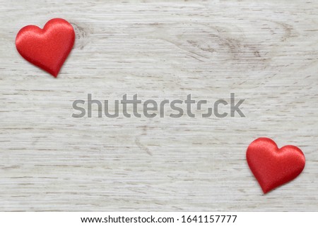 Wooden background with two hearts, place for text. Greeting card. Valentine's day, love, passion.