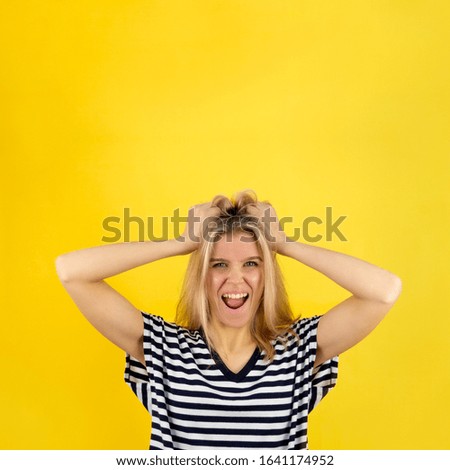 Woman in surprise joy grabbed her hair. Blonde girl surprised and shocked looks on you and screaming with delight. Expressive facial expressions emotions of fun and pleasure
