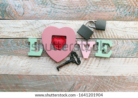 Decor for Valentine's Day, wedding, romantic greetings, the word love from volume letters, locks, keys, hearts, top view