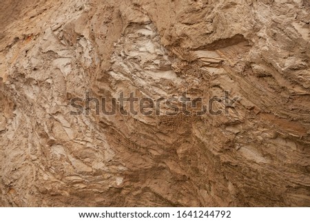 Natural blurred background, selective focus. The structure of different layers of earth in a clay quarry after geological study of the soil. environmental conservation.
