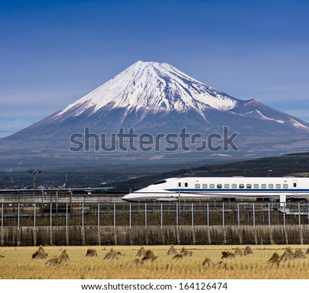 Mt. Fuji in Japan with passing train. Royalty-Free Stock Photo #164126474
