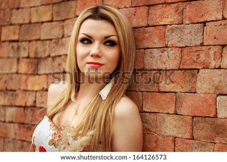Beautiful Young Woman Relaxing With Old Brick Wall