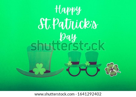 St Patricks Day phrase, different photo booth props for St Patricks Day party, top view, green background
