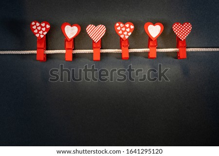 Valentine's day, romantic still life, hearts on a clothespin, on a gray background. Beautiful holiday picture.