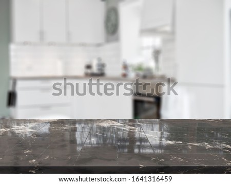 Stone table top and blurred kitchen interior background - can used for display or montage your products.