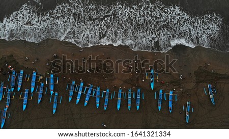 Fishing boats that lean on the beach with good wave texture