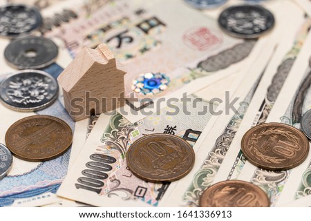 Close up little wooden house on japanese currency yen money banknote. Background concept for japan  real estate industry economy.