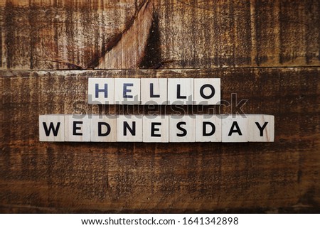 Hello Wednesday alphabet letter with space copy on wooden background