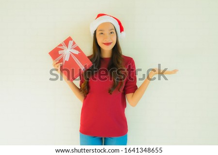 Portrait beautiful young asian women wear santa hat in christmas festival with gift box for celebration