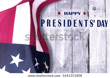 Happy presidents day with flag of the United States on wooden background.
