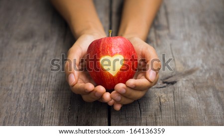 Red Apple with engraved heart Royalty-Free Stock Photo #164136359