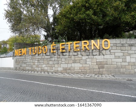 wall with the phrase "not everything is eternal", in the city of Guimarães, Portugal. Translation - not everything is eternal.