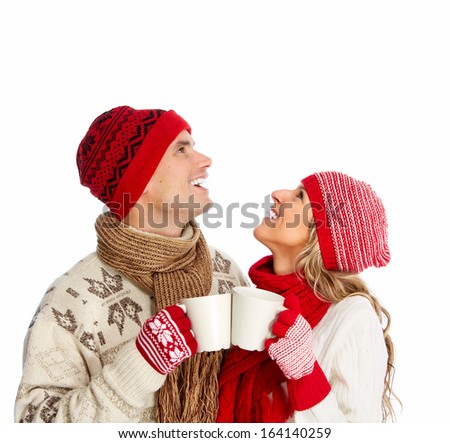 Christmas couple drinking hot tea isolated over white background.