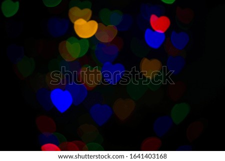 Multi-colored bokeh lights in a heart shape, black scene