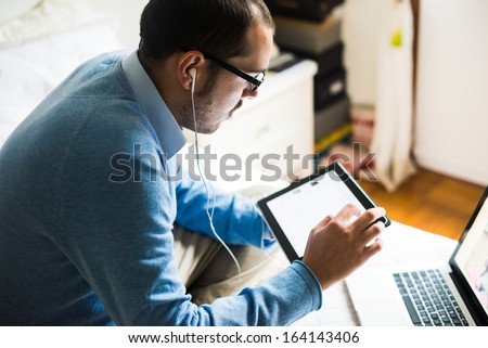 elegant business multitasking multimedia man using devices at home Royalty-Free Stock Photo #164143406