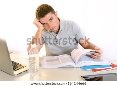 Overwhelmed  Stressed Student  with Book and Laptop