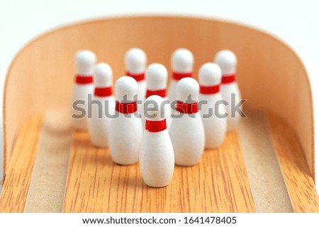 Closeup of a wooden mini bowling game set and pins on wood lane